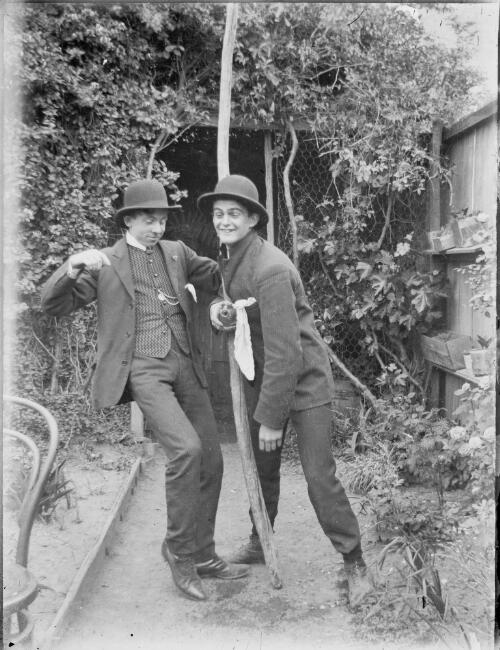 Two men leaning against each other in a garden, Australia, ca. 1900 [picture]