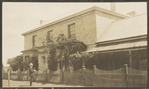 Man standing outside a two storey house, east coast of Tasmania, ca. 1925 [picture] / E.W. Searle