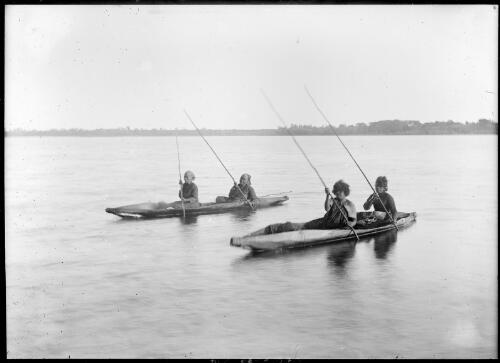 Four people sitting in two canoes, Lake Tyers, Victoria, ca 1900 [picture]