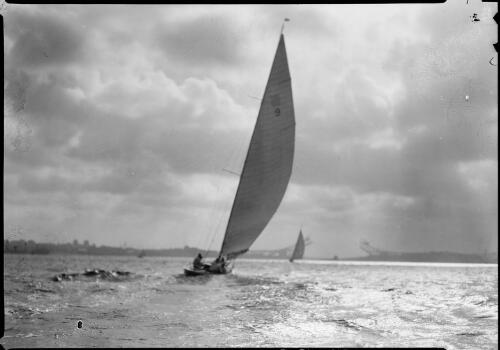 Sailing on the harbour, with an incomplete bridge in the distance, Sydney Harbour, ca. 1931 [picture] / E.W. Searle
