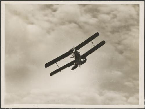 VH-UGK, an Alexander Eaglerock A-2, in flight, Mascot Airport, Sydney, ca. 1932, 2 [picture] / E.W. Searle