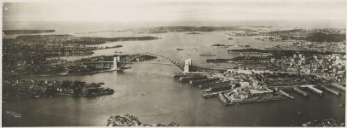 Aerial view of Sydney Harbour with the Sydney Harbour Bridge in the foreground, Sydney Harbour, ca. 1935 [picture] / E.W. Searle