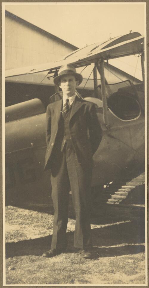 E.W. Searle standing beside Henry Goya's General Aircraft Genairco, VH-UOG, Newcastle, New South Wales, ca. 1934 [picture] / E.W. Searle