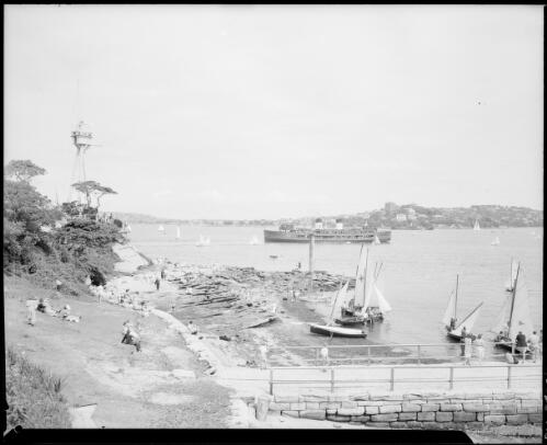 Harbour control tower, sailing boats by the waters edge and a ferry in the background, Sydney Harbour, ca. 1947, 1 [picture] / E.W. Searle