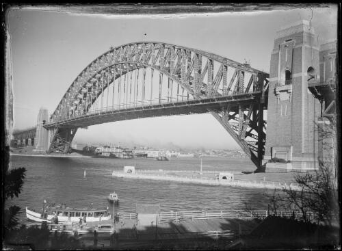 Sydney Harbour Bridge from Kirribilli with passengers embarking on a passenger ferry in the foreground, Sydney Harbour, ca. 1935 [picture] / E.W. Searle
