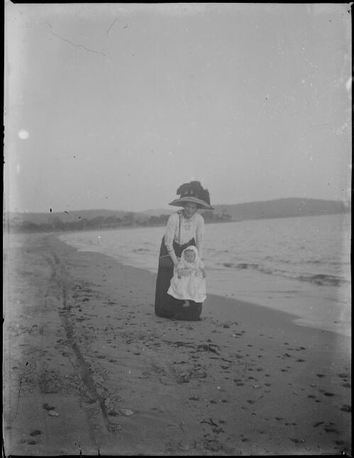 Woman with a baby on a beach, Australia, ca. 1900, 1 [picture] / E.W. Searle