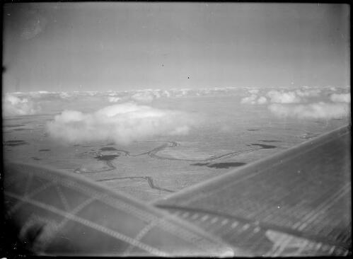 Aerial view of a river with a wing and an engine in the foreground, Australia, ca. 1945 [picture] / E.W. Searle