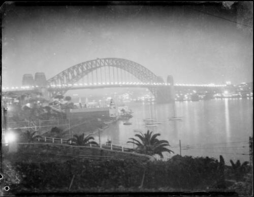 Night view of Sydney Harbour Bridge with Luna Park in the foreground, Lavender Bay, Sydney Harbour, ca. 1935 [picture] / E.W. Searle