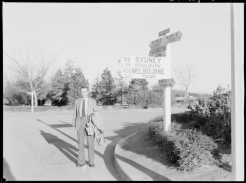 E.W. Searle standing beside a road sign, London Circuit, Canberra, ca. 1949 [picture] / E.W. Searle