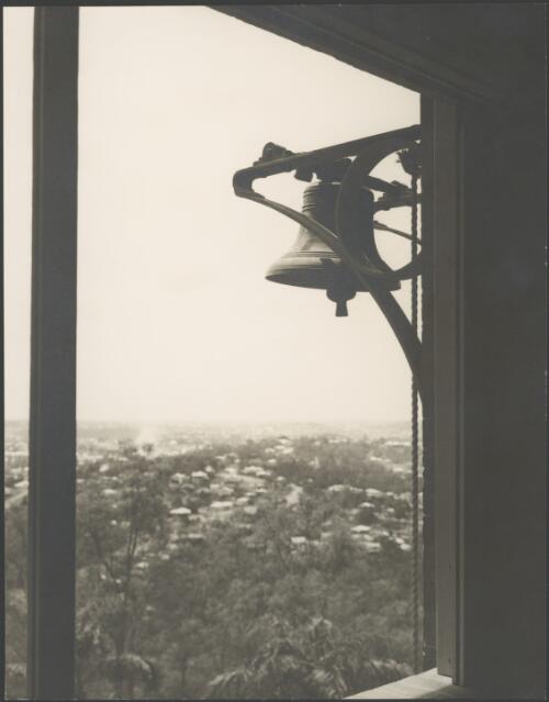 Bell viewed through a window with city background, Stuartholme School, Toowong, Queensland, ca. 1949 [picture] / E.W. Searle