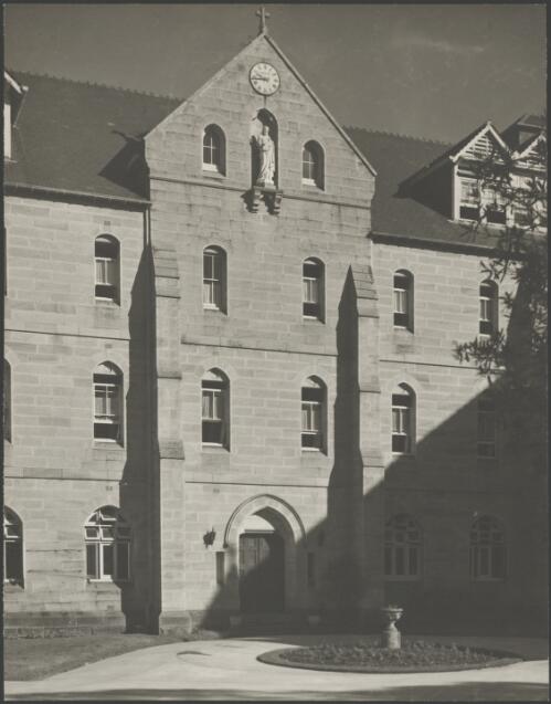 Statue of Jesus below a clock above a doorway, Stuartholme School, Toowong, Queensland, ca. 1949 [picture] / E.W. Searle
