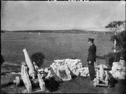 Uniformed man beside the Garden Island Battery, Garden Island, Sydney Harbour, ca. 1935 [picture] / E.W. Searle
