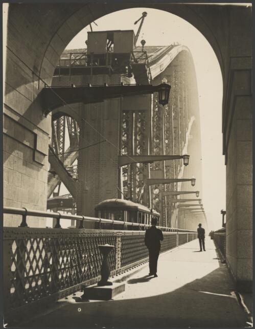 Pedestrians and a tram on the Sydney Harbour Bridge, ca. 1935 [picture] / E.W. Searle