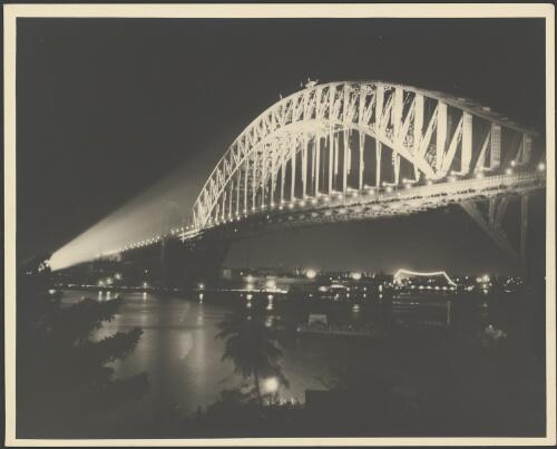 Sydney Harbour Bridge at night from Kirribilli, illuminated with floodlights, Sydney Harbour, ca. 1935 [picture] / E.W. Searle