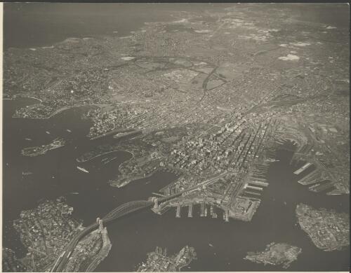 Aerial view of Sydney looking south from the Harbour Bridge towards Maroubra, Sydney Harbour, ca. 1935 [picture] / E.W. Searle