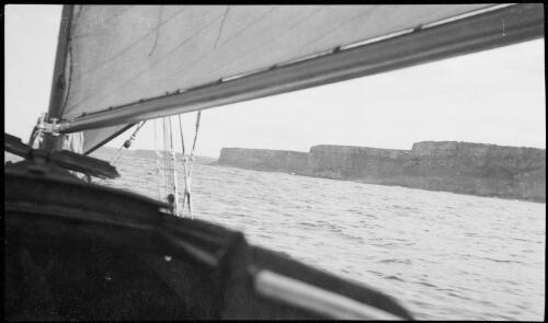 Ocean side of North Head viewed from a sailing boat, Sydney Harbour, ca. 1935 [picture] / E.W. Searle