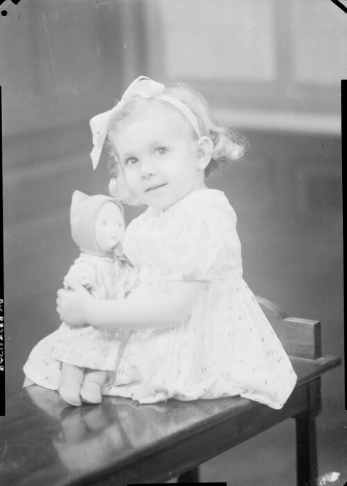 Portrait of a young girl with a doll, Australia , ca. 1945 [picture] / E.W. Searle