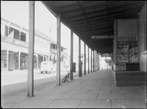 Street scene viewed from covered shop front, Australia, ca. 1945, 1 [picture] / E.W. Searle