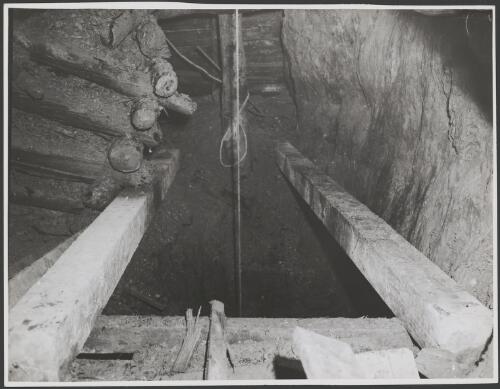 Rope under tension passing down a mineshaft, Australia, ca. 1935 [picture] / E.W. Searle