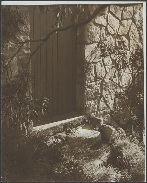 Stone block wall with stone steps leading to a wooden door, Australia, ca. 1935 [picture] / E.W. Searle