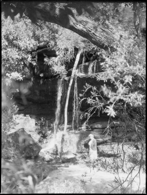 Mrs Searle at the base of a waterfall, Oxford Falls, Sydney, 1945, 2 [picture] / E.W. Searle