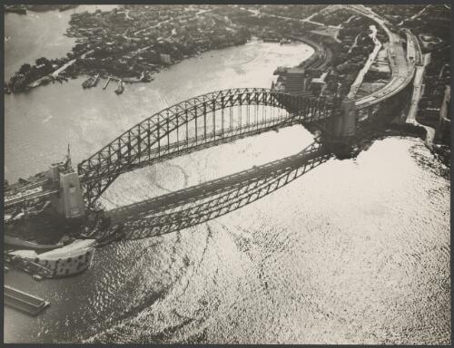 Aerial view of an incomplete Sydney Harbour Bridge with Lavender Bay in the background, Sydney Harbour, 1931, 1 [picture] / E.W. Searle