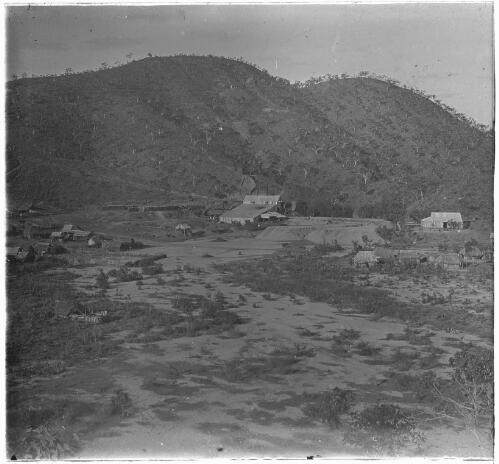 Mine site below a hillside partly stripped of trees, Australia, ca. 1920 [transparency] / E.W. Searle