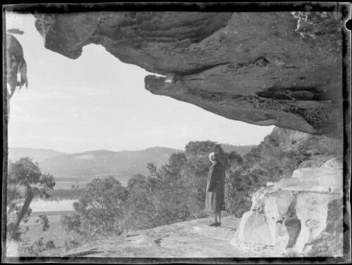 Mrs Searle standing at the mouth of Court House Cave, Wisemans Ferry, Hawkesbury River, New South Wales, ca. 1945, 2 [picture] / E.W. Searle