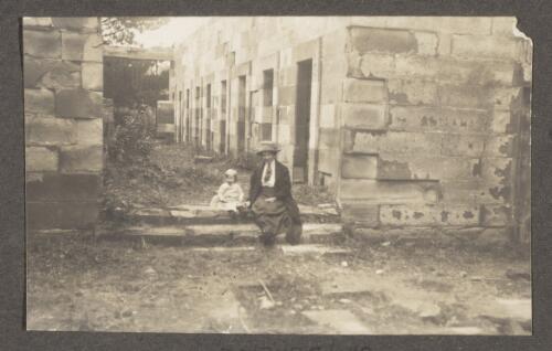 Mrs Edward Searle and son Allan sitting on the steps of the Model Prison [Port Arthur, Tasmania], Easter, 1913 [picture]
