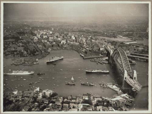 Aerial view of Sydney and Circular Quay on the day of the official opening of the Sydney Harbour Bridge, 19 March, 1932 [picture] / E. W. Searle