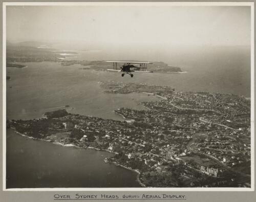 American Eagle model A-1 biplane VH-UHV in flight above Sydney Heads, 19 March 1932 [picture] / E. W. Searle