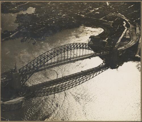 Aerial view of Sydney Harbour Bridge at sunset, Sydney, ca. 1940 [picture] / E.W. Searle