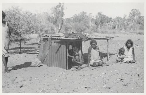 Native family in front of their dwelling or humpy at Umba Kumba, Groote Eylandt, May 1948 [picture] / Frank M. Setzler