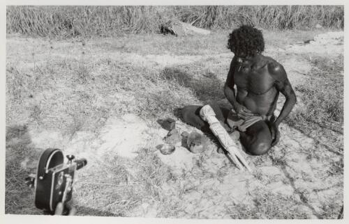 Carving and painting of wooden figurine at Yirrkala, August 1948 [picture] / Frank M. Setzler