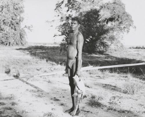 Kumbiala holding a large snapper and small brim, caught while spear fishing, Arnhem Land, Northern Territory, 4 June 1948 [picture] / Frank M. Setzler
