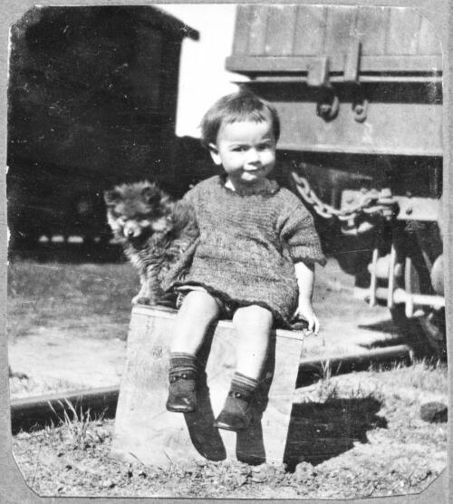 Jean sitting on a wooden box with a small dog, during the St. Leon and Sole Brothers Circus and Zoo tour of Australia, Western Australia 1924 [picture]