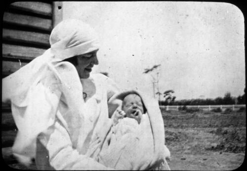 Nurse and baby Andrew John [transparency] : taken on survey trip undertaken in 1927 by Rev. J.A. Barber and Dr. George Simpson for the Flying Doctor Scheme