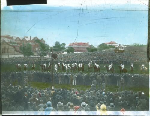 Crowds of people watching horses gathered at a race meeting [transparency] : a deputation lantern slide of the AIM [Australian Inland Mission] Head Office, 1926-1940 / [John Flynn?]