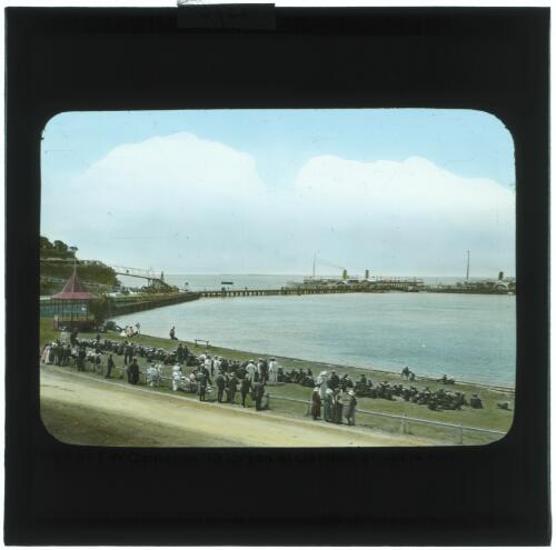 People gathered at pier with paddle steamers in background, Sorrento, Victoria [transparency] / [John Flynn?]