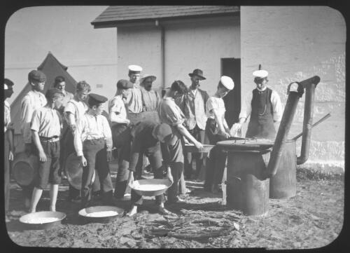 Australian naval cadets lined up with large metal pans [transparency] : miscellaneous glass slide / [John Flynn?]