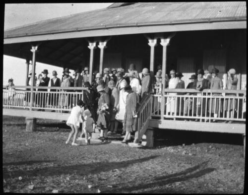 Women gathered on the verandah of Camooweal hall [transparency] : a deputation lantern slide of the AIM [Australian Inland Mission] Head Office, 1926-1940 / [John Flynn?]