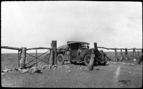 Dodge truck in the border gate between Queensland and Northern Territory [transparency] : taken on survey trip undertaken in 1927 by Rev. J.A. Barber and Dr. George Simpson for the Flying Doctor Scheme