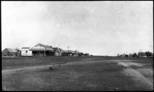 View of a town with stores and buildings, Northern Territory [Bonlia?] [transparency] : taken on survey trip undertaken in 1927 by Rev. J.A. Barber and Dr. George Simpson for the Flying Doctor Scheme