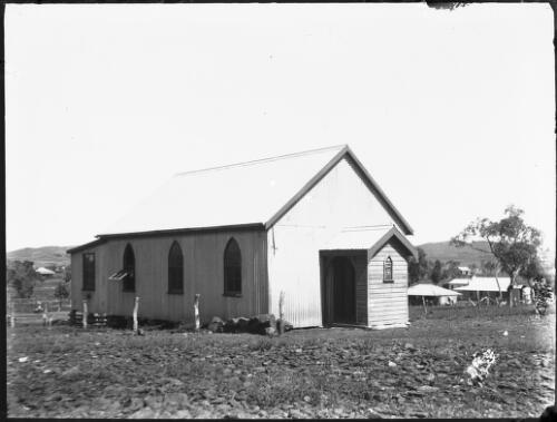 Unidentified weatherboard church with houses in the background [2] [picture] : Fred McKay Cape York Peninsula and West Queensland Patrol 1938-1940 / [Fred McKay]