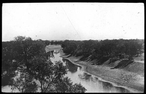 Unidentified river running low on banks [transparency] : a deputation lantern slide of the AIM [Australian Inland Mission] Head Office, 1926-1940 / [John Flynn?]