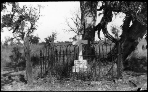 Grave of Lyndsay Crawford in a cemetery [transparency] : taken on a survey trip undertaken in 1927 by Rev. J.A. Barber and Dr. George Simpson for the Flying Doctor Scheme