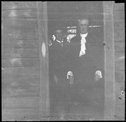 Two unidentified men standing in doorway [transparency] : lantern slide used by Rev. F.H. Paterson, north South Australia / [John Flynn?]