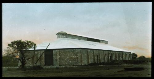 Newly constructed building with corrugated iron roof [transparency] : a lantern slide used by John Flynn in lectures / [John Flynn]