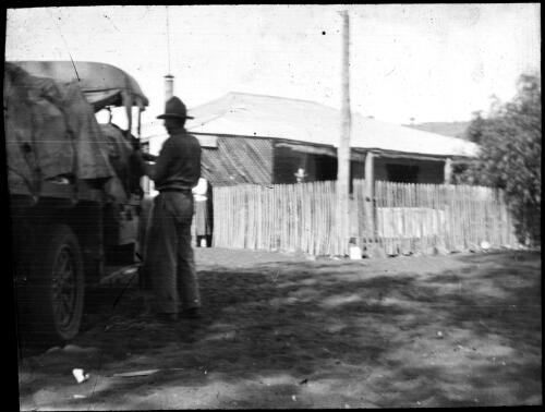 Man packing a car [transparency] : a deputation slide of the AIM [Australian Inland Mission] Head Office, 1926-1940 / [John Flynn?]