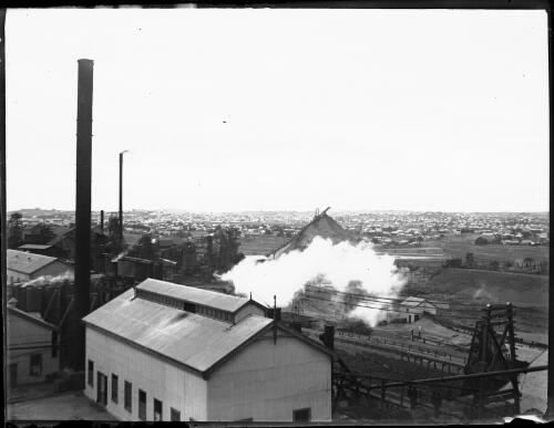 Unidentified industrial area with several buildings and large chimneys [picture] : Fred McKay Cape York Peninsula and West Queensland Patrol 1938-1940 / [Fred McKay]
